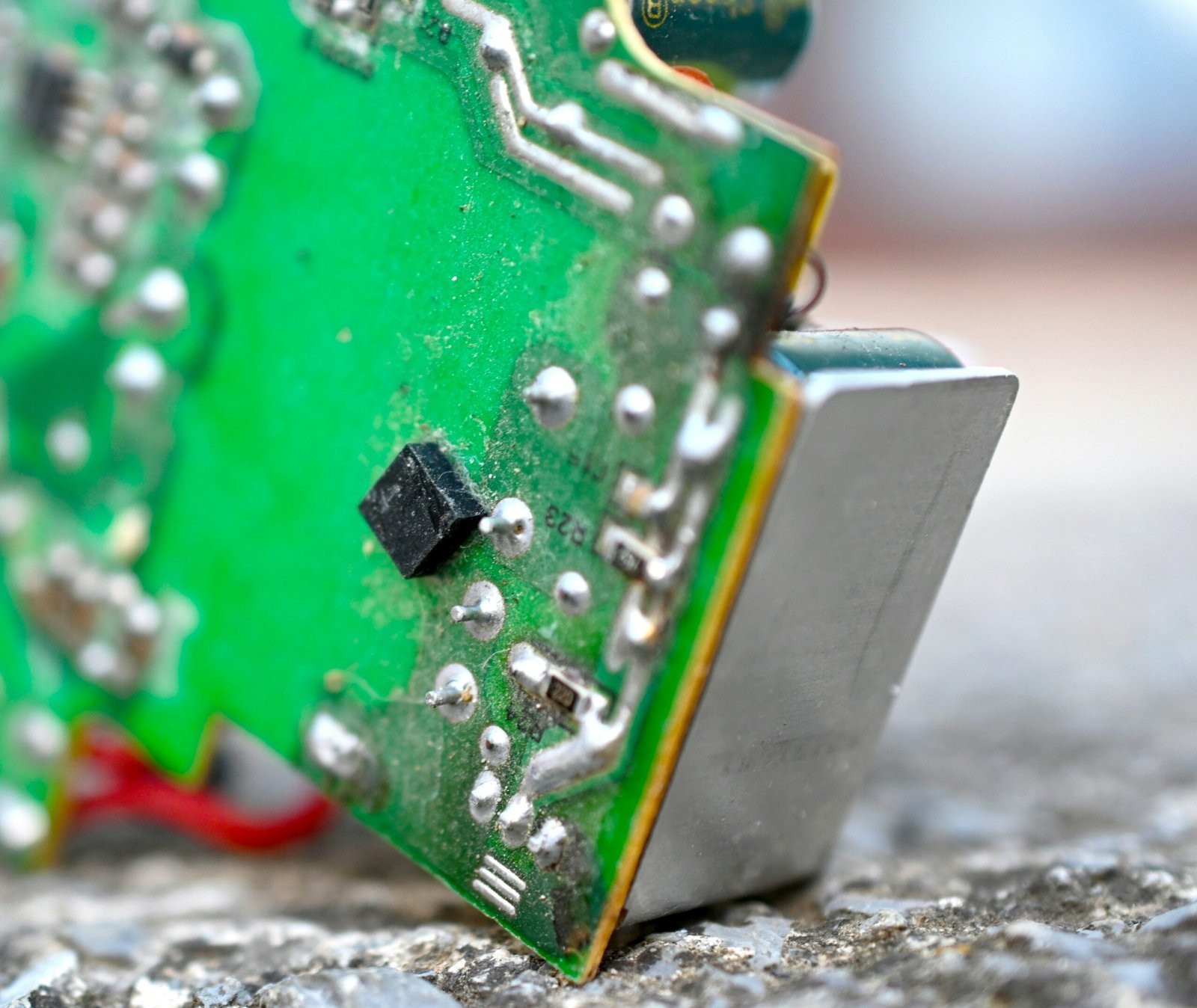 A close up of a circuit board on the ground